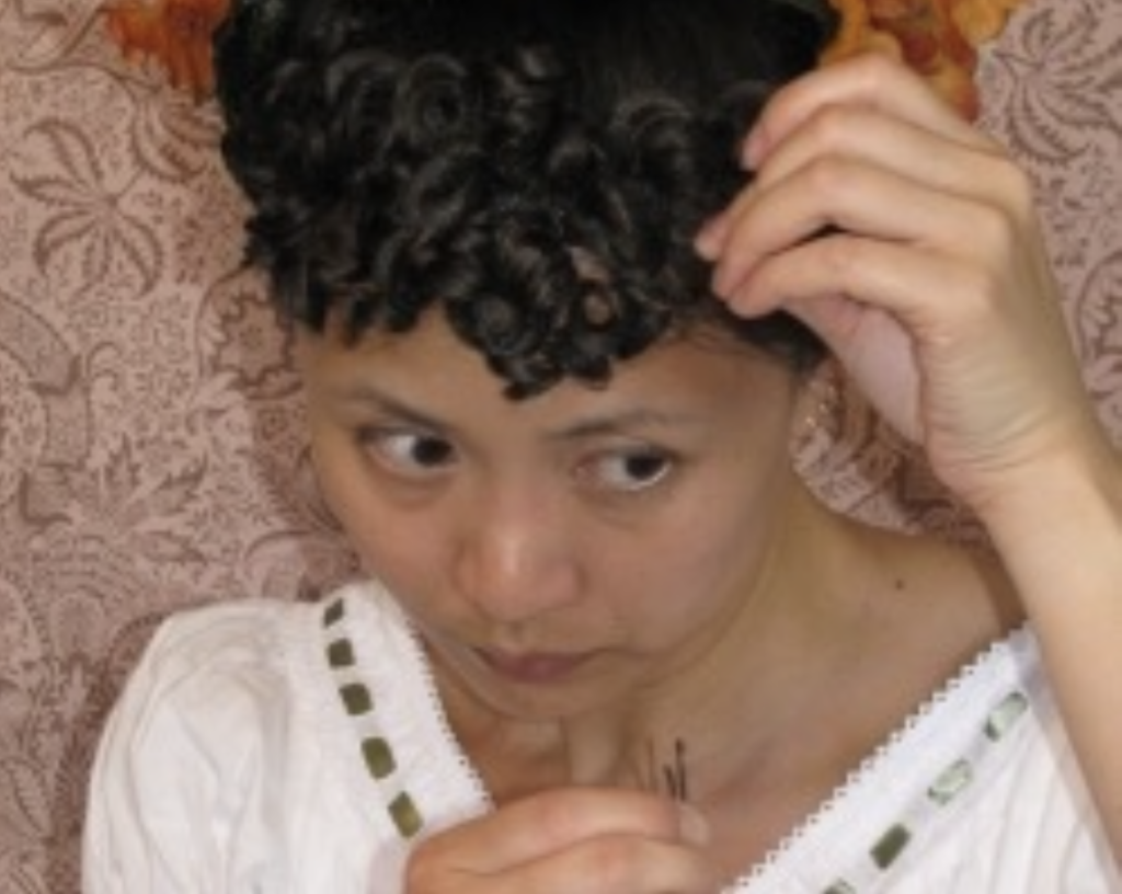 Photo showing pinning in of curly bangs